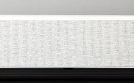 The LG HU715QW 4K UST projector sits on a stand.