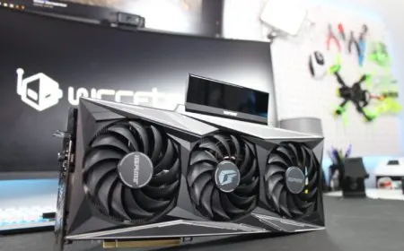 A Colorful iGame GeForce RTX 3090 Ti Vulcan-OC graphics card features quad-slot cooling and an LCD display panel.