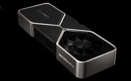 A graphics card with a black metal casing and dual cooling fans rests on a plain surface.