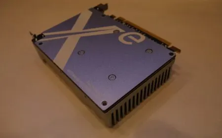 The Intel Xe-HPG DG2 graphics card board is shown with visible cooling components and connector ports.