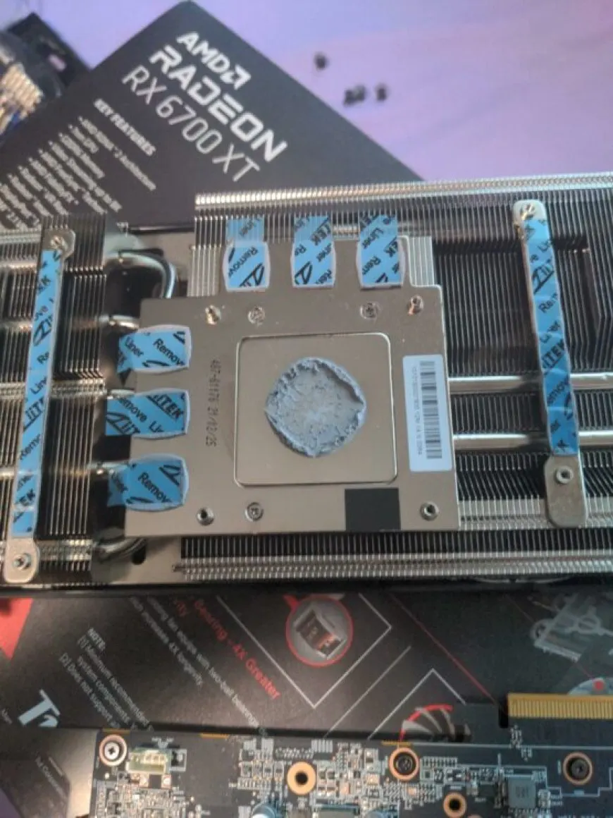 The PowerColor RX 6700 XT graphics card ships with thermal pad covers still attached, which can cause high temperatures.