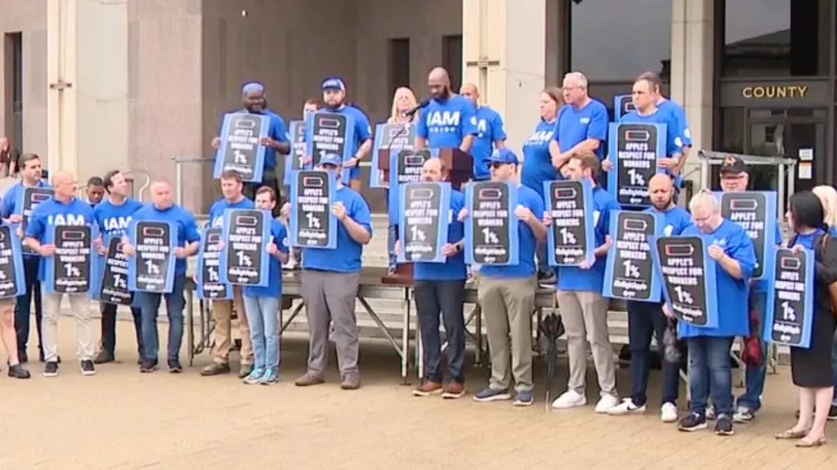 Union workers rally outside Apple Towson store to protest closure and alleged discriminatory practices.
