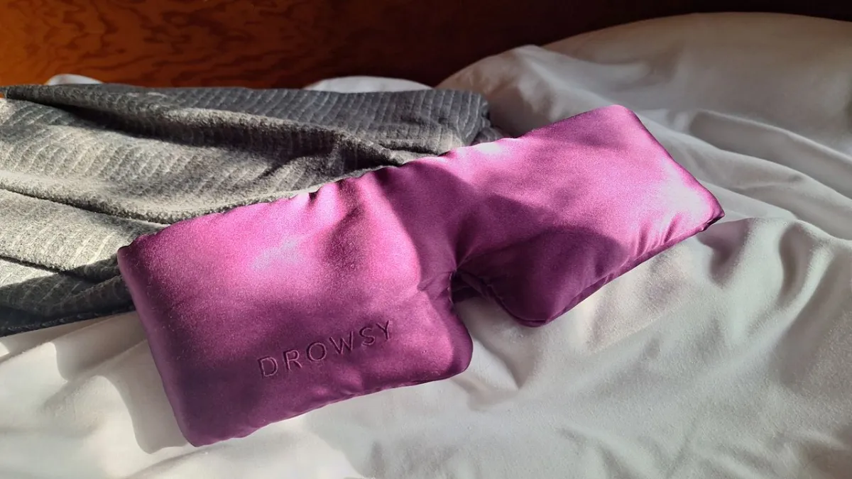Two contoured sleep masks rest side by side on a light surface.