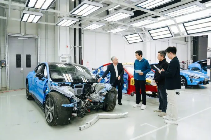 Xiaomi CEO presenting the new SU7 electric sedan during a factory broadcast
