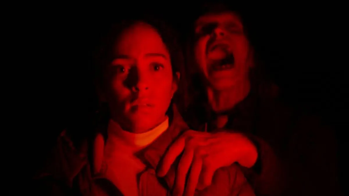 The film still captures tense road trip dread through dramatic lighting and confined interior framing.
