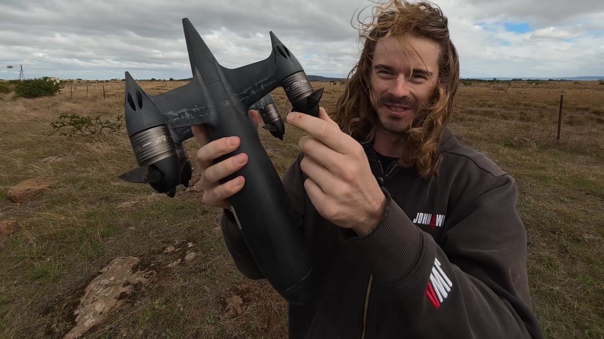A custom drone equipped with sawtooth carbon fiber propellers flies during a high speed record attempt.