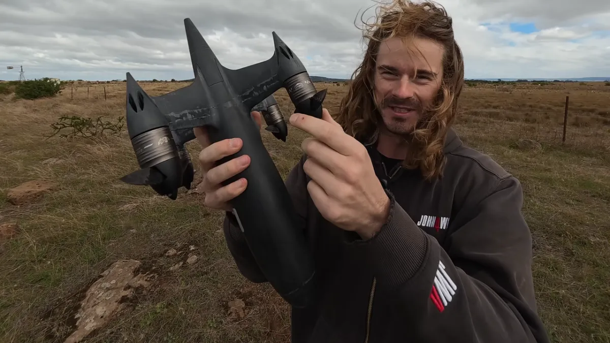 A custom drone equipped with sawtooth carbon fiber propellers flies during a high speed record attempt.