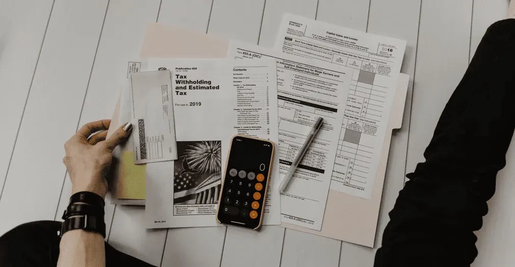 A tax professional reviews financial documents during a client consultation.