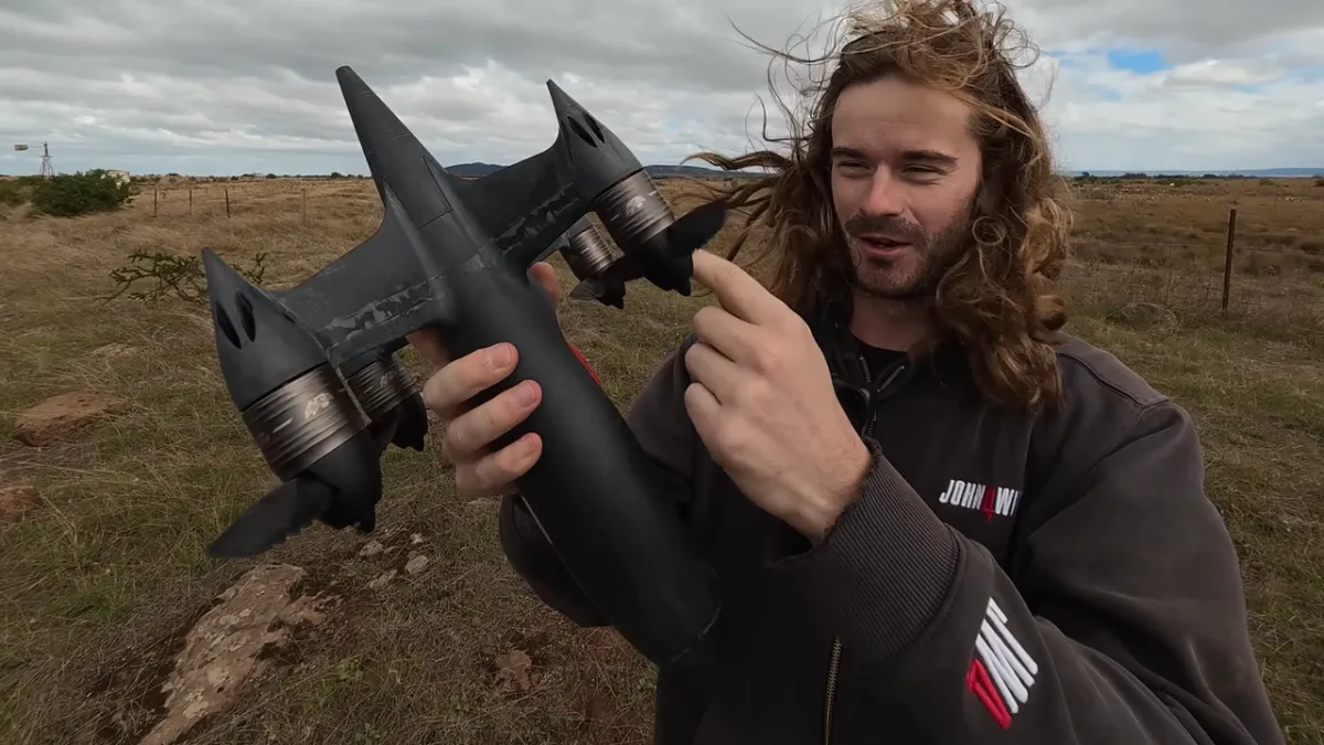 A custom drone features carbon fiber propellers with sawtooth leading edges during a controlled high-speed test.
