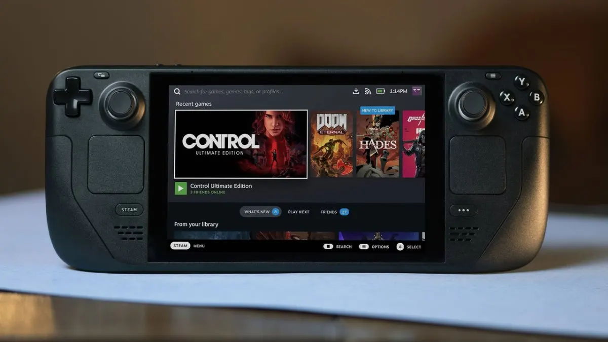 A handheld gaming PC rests on a surface with its screen and controls clearly visible.