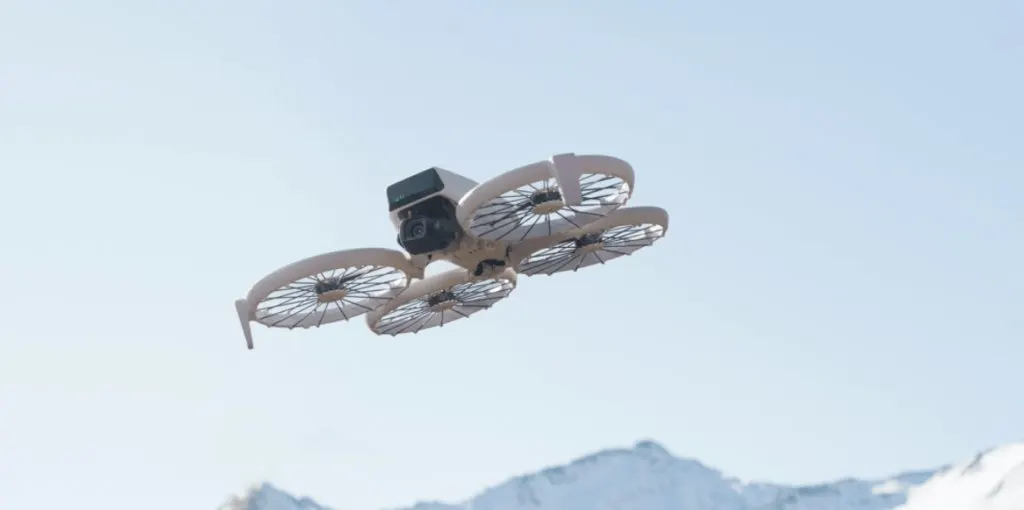 A DJI drone in flight against a clear sky