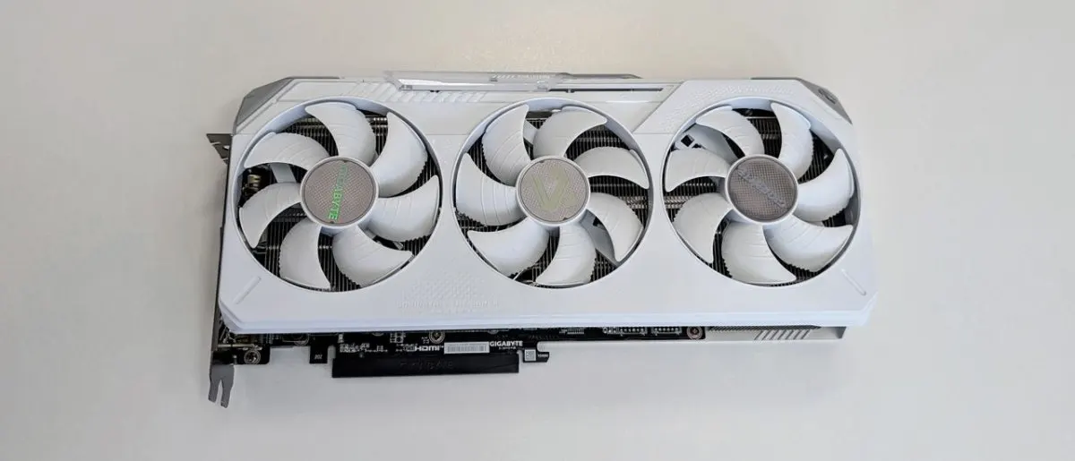 The white Gigabyte Radeon RX 9070 XT Gaming OC Ice graphics card features a triple fan cooling design.