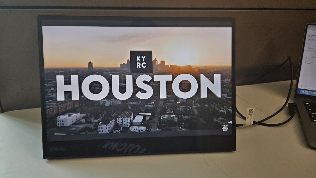 The Lenovo ThinkVision M14t Gen 2 portable monitor is shown with its built-in stand extended and USB ports visible.
