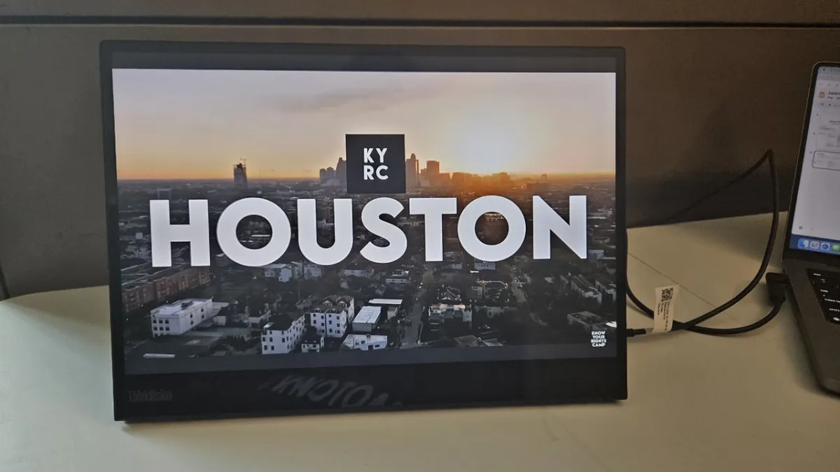 The Lenovo ThinkVision M14t Gen 2 portable monitor is shown with its built-in stand extended and USB ports visible.
