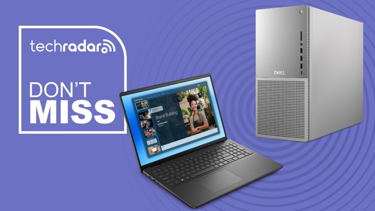 Dell business laptops and desktop towers are arranged on a promotional display table.