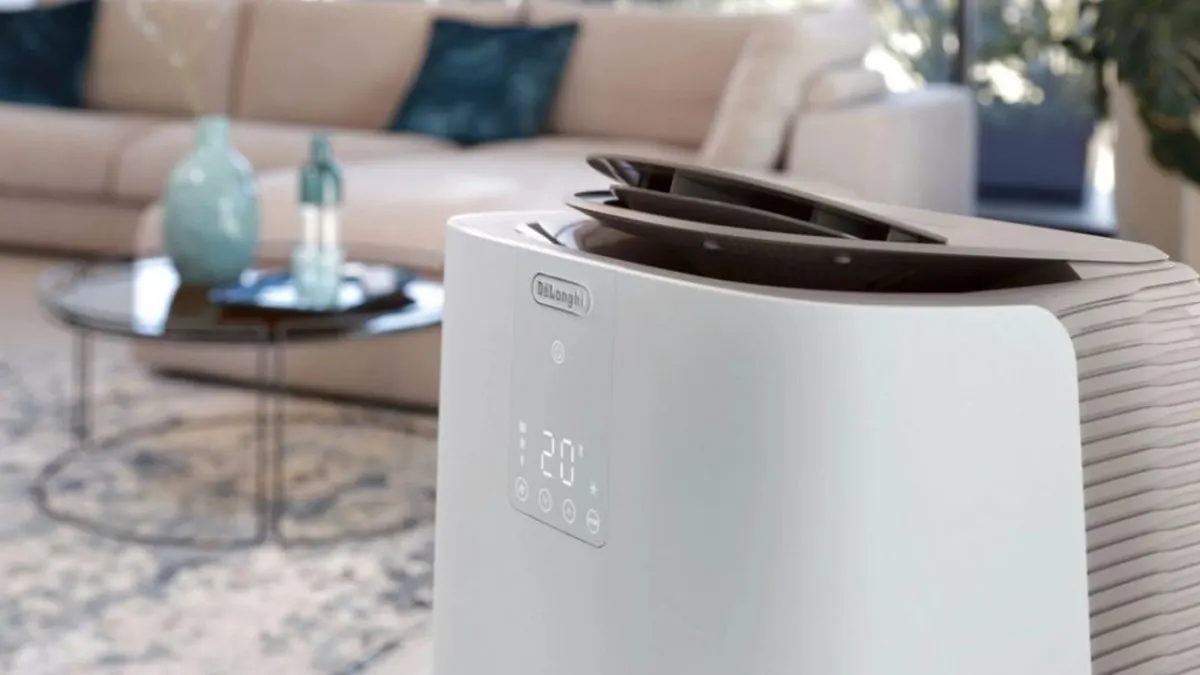 A white De'Longhi Pinguino GentleJet portable air conditioner displays its control panel and exhaust hose.