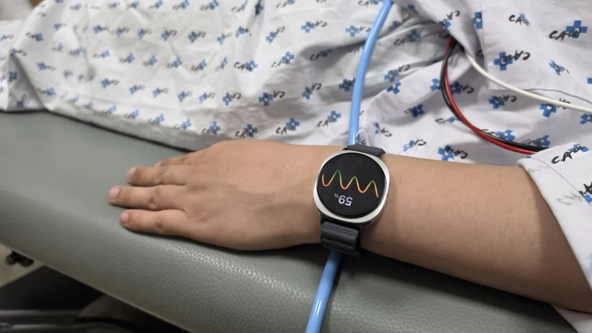 The Samsung Galaxy Watch displays heart rate metrics used for fainting prediction.