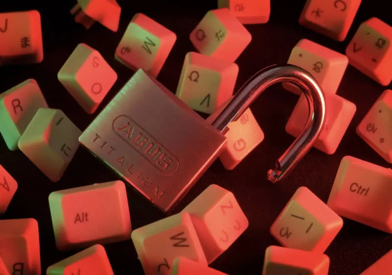 A USB drive connects to a computer to demonstrate the YellowKey exploit targeting Windows BitLocker encryption.