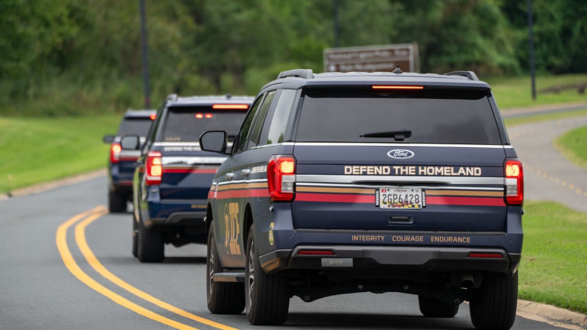 A concealed federal license plate is mounted on a vehicle.