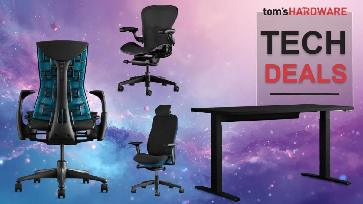 A Herman Miller ergonomic chair sits next to an adjustable desk in a bright workspace.