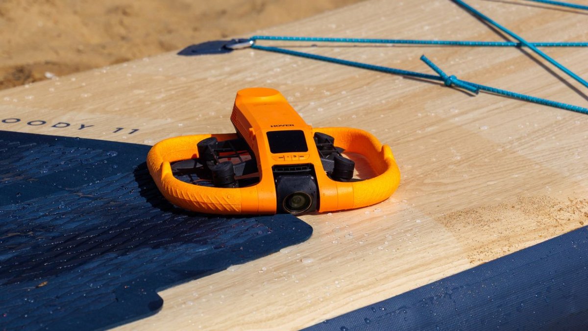 The HoverAir Aqua waterproof drone hovers above water.