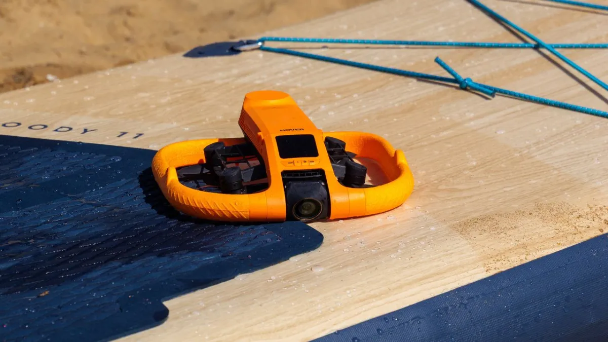 The HoverAir Aqua waterproof drone hovers above water.