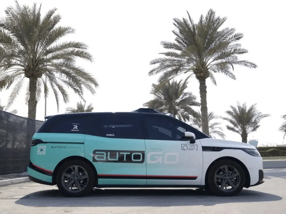 A Baidu Apollo Go autonomous taxi travels along a street in Abu Dhabi.