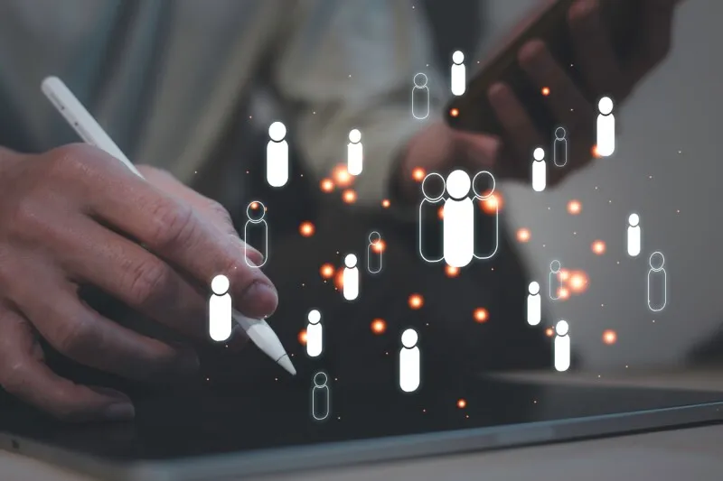 A computer screen displays hiring metrics alongside diverse candidate silhouettes to illustrate algorithmic bias.