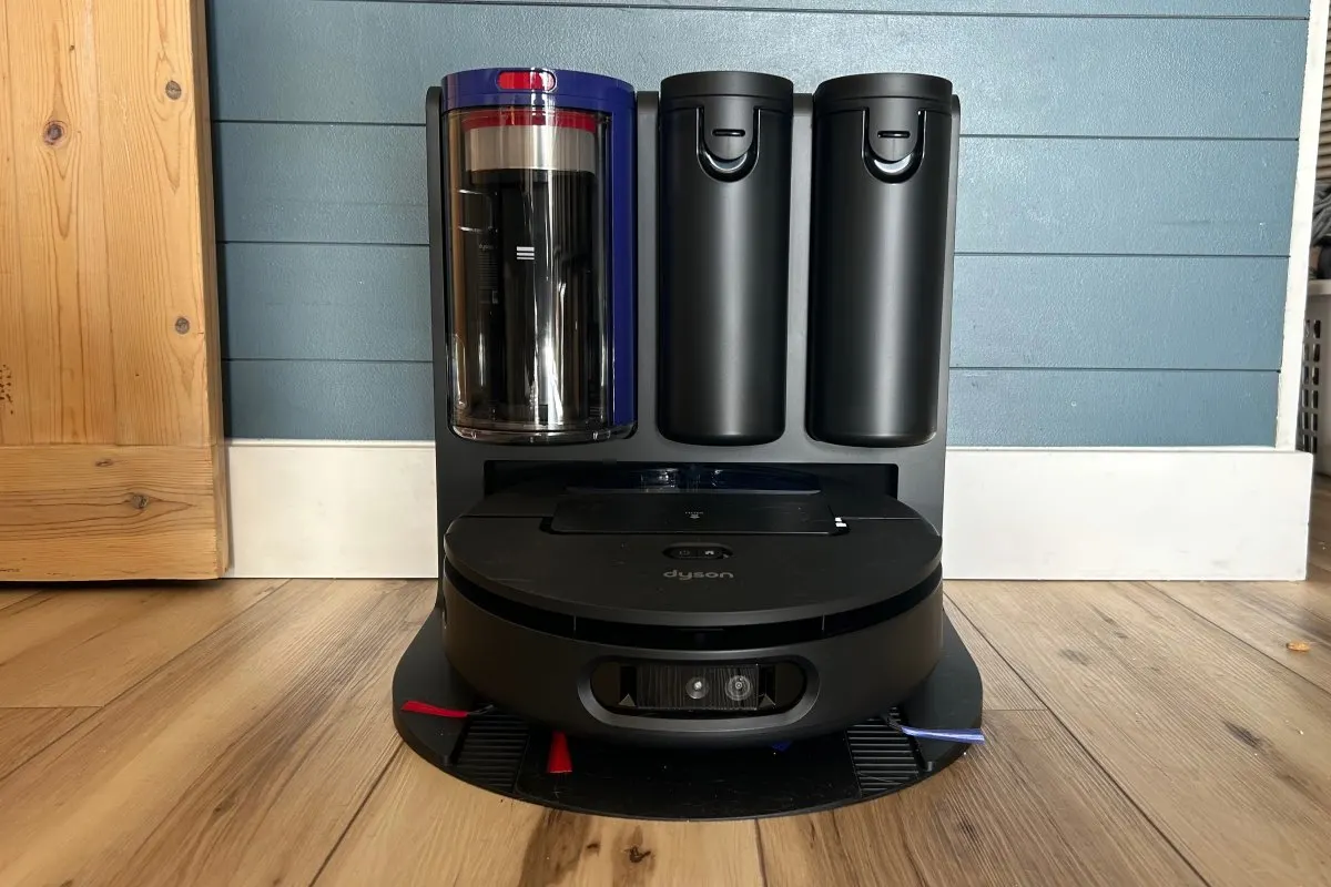 The Dyson Spot+Scrub AI robot vacuum and mop navigates a hard floor.