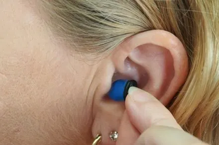 Standard earbuds capture heartbeat vibrations through accelerometers to verify user identity passively.
