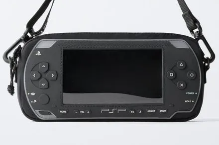 Black crossbody bag modeled after the original PlayStation Portable console with embossed controls and silicone detailing.
