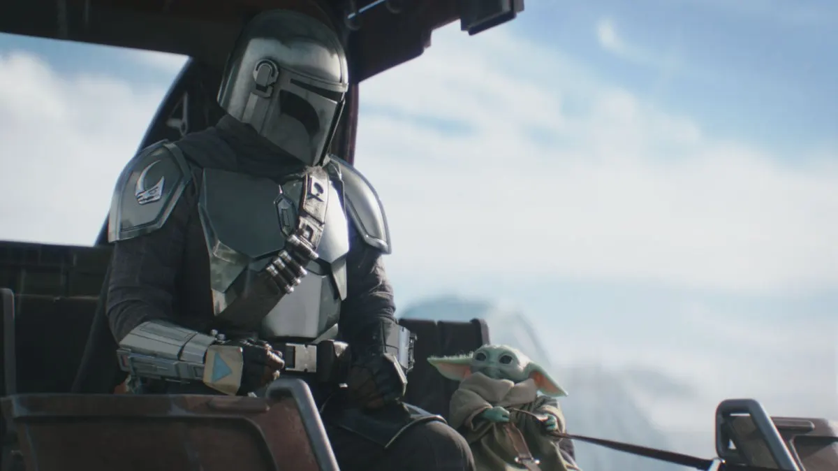A theater marquee displays the theatrical release title for The Mandalorian and Grogu.