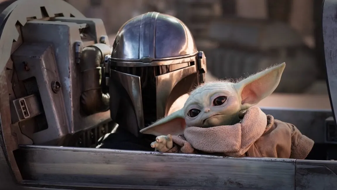 The Mandalorian and Grogu stand together in a cinematic scene that emphasizes their bond.