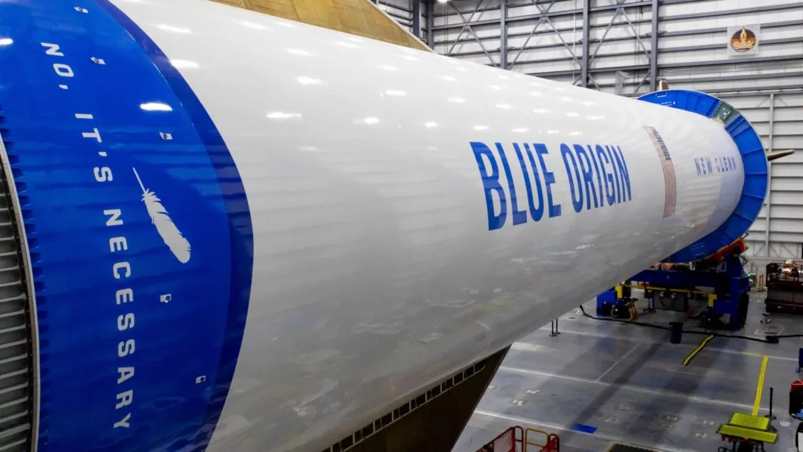The Blue Origin New Glenn rocket stands ready for Amazon broadband satellite deployment.