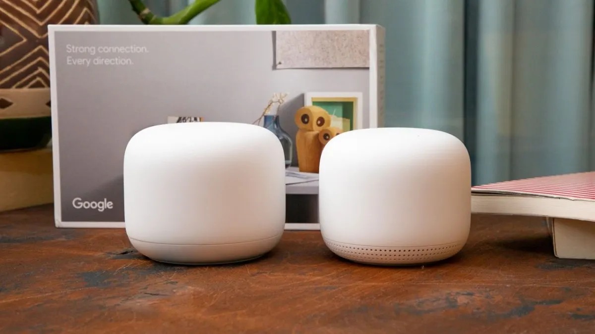 The Google Nest Wifi router and wireless point rest on a flat surface.