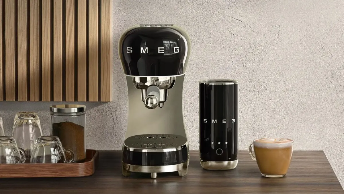 A Smeg ECF12 thermoblock espresso machine is displayed alongside a Mini Milk Frother