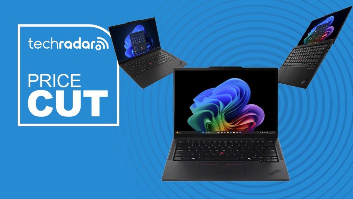 A lineup of Lenovo ThinkPad and ThinkBook 14 inch business laptops sits on a desk.