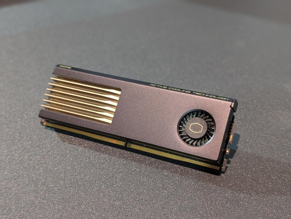 RAM modules fitted with active cooling fans and thermal monitoring displays installed on a motherboard.