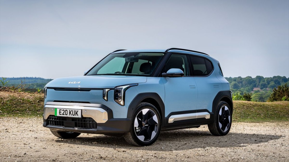 The Kia EV2 compact electric vehicle is parked on a city street.