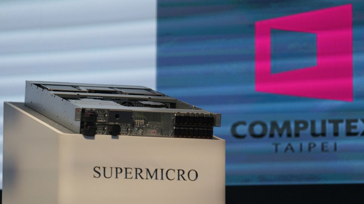Rows of Supermicro server racks are positioned in a data center.