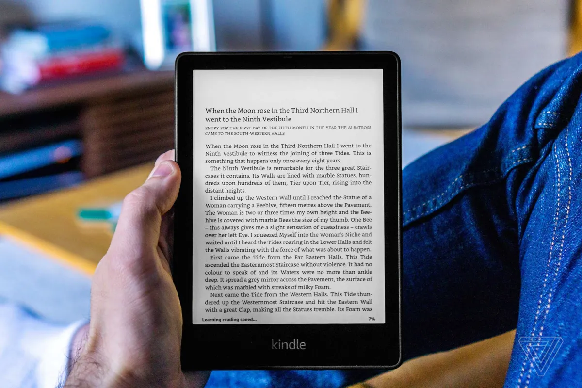 A close-up of the 2021 Kindle Paperwhite e-reader displaying a book page on its 6.8-inch screen.