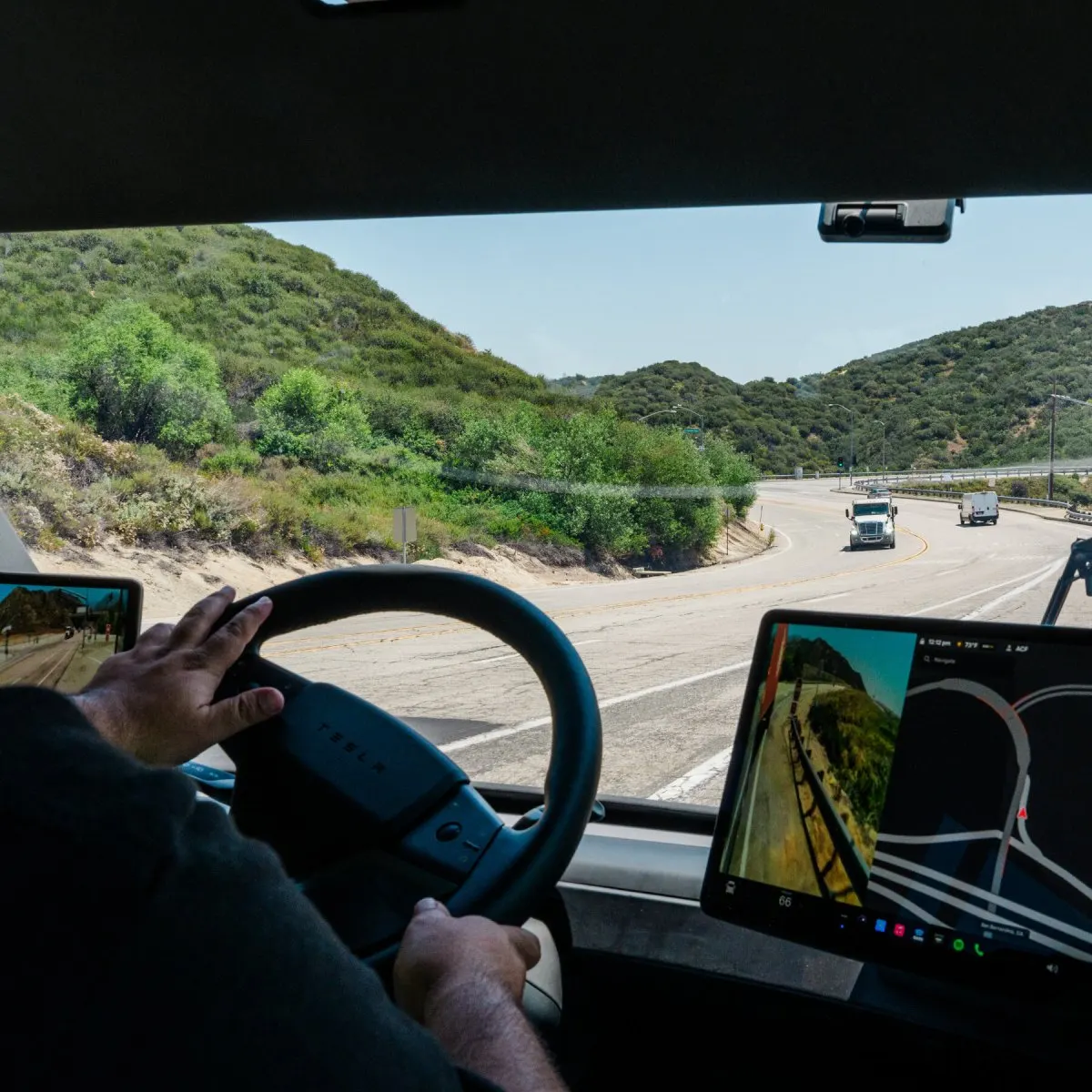 A Tesla Semi electric truck is parked on a California highway.