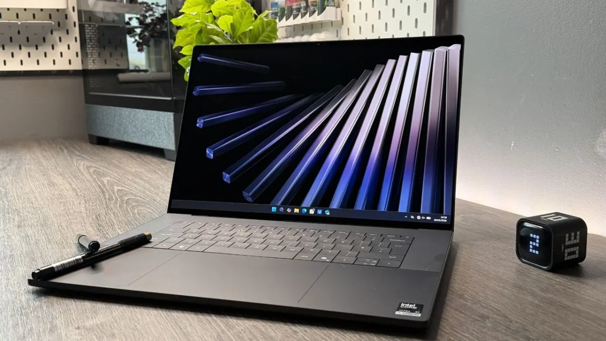 The Dell XPS 16 2026 laptop is shown open with its OLED screen active.