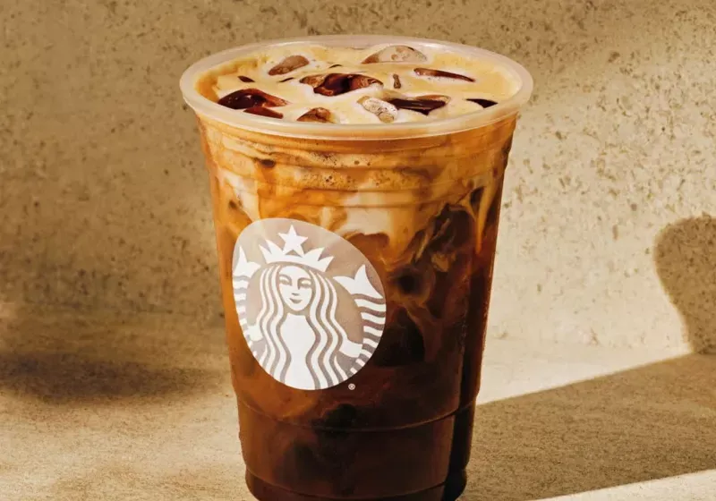 Starbucks syrup bottles arranged on a shelf.
