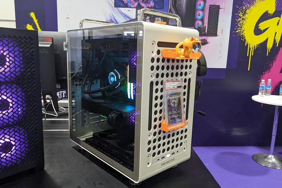 Gaming audio equipment and peripherals are displayed at a technology exhibition highlighting current hardware pricing trends.