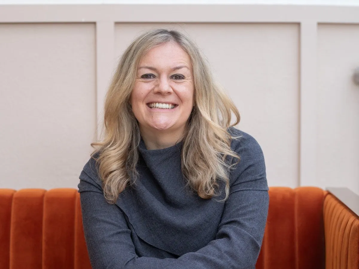 Professional portrait of Andreea Wade discussing artificial intelligence infrastructure.