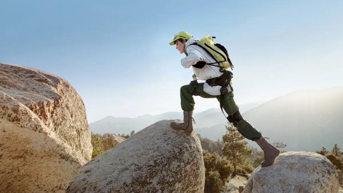 A person wears the Hypershell X Ultra S exoskeleton to demonstrate the AI motion control features.