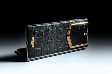 Vertu Alphafold foldable smartphone with alligator leather and gold accents.