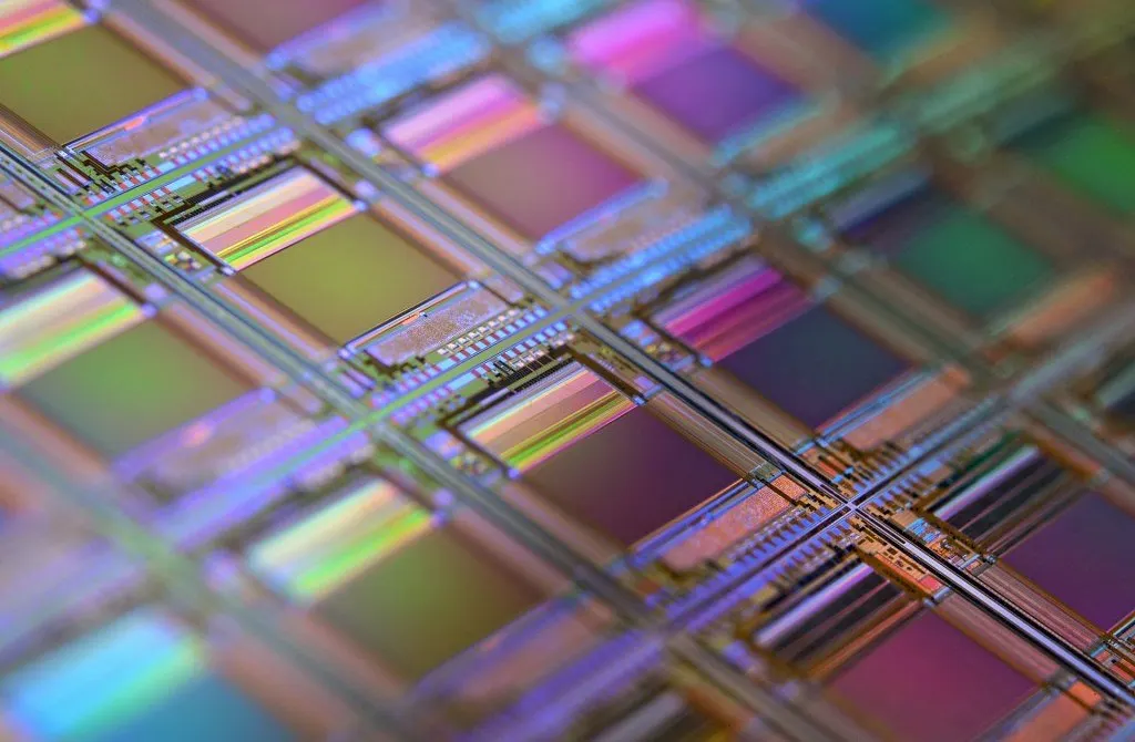 Advanced semiconductor wafers and integrated circuit layouts illustrate domestic chip design progress.