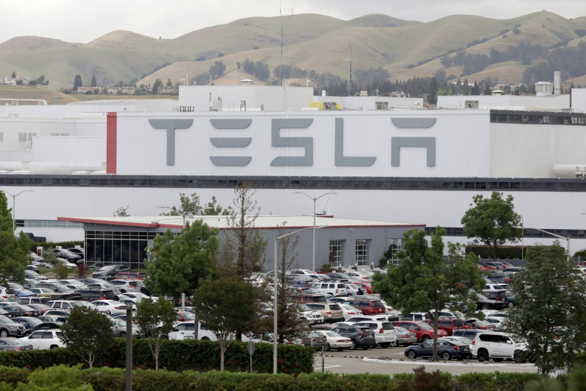 Tesla hits record high as shares surpass $1,000 for first time